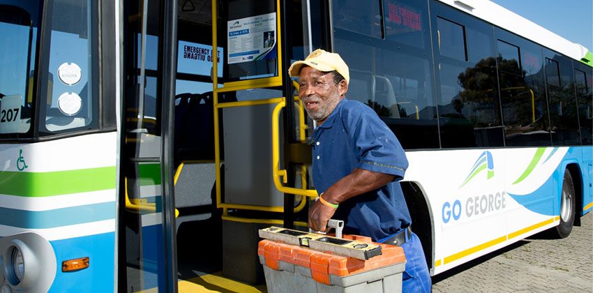 Worker with toolbox taking Go George bus