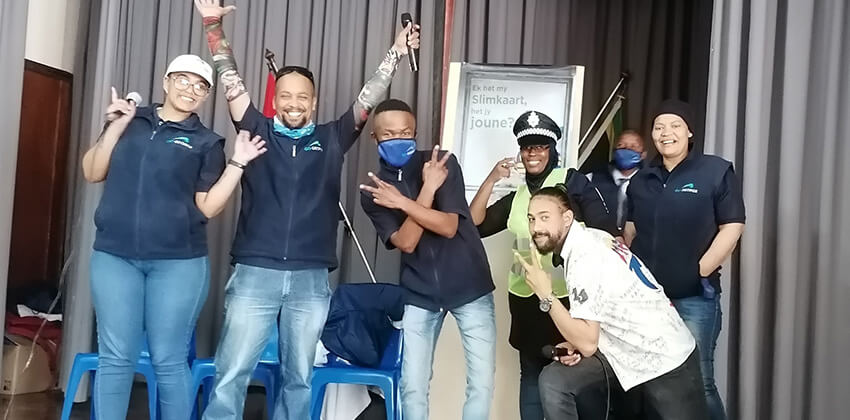 The group of communication champions who form the drama group posing for a fun photo on the stage of the school hall at Van Kervel School.