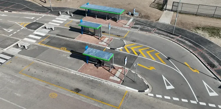 A bus terminus with several lanes and bus shelters.