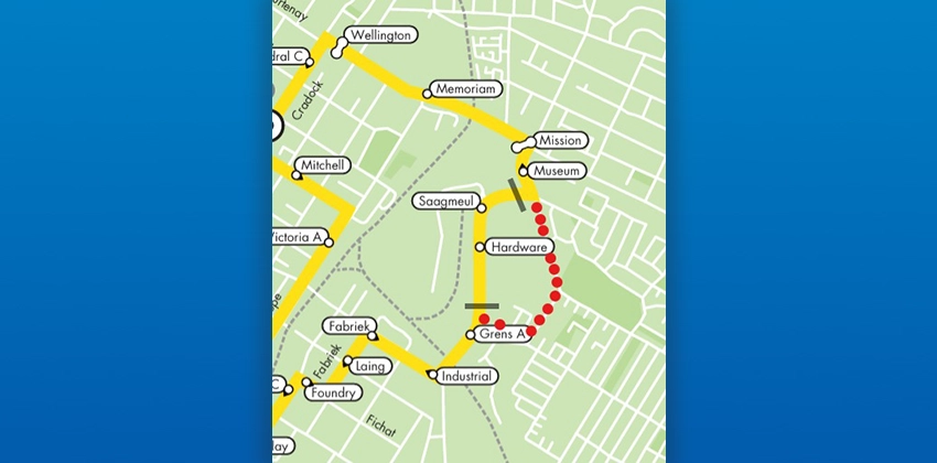 A bus route map showing the Route 9F reroute in an urban area. The active route is highlighted in yellow, traveling through streets including Wellington, Mitchell, Victoria Avenue, Fabriek, Laing, Industrial, and Grens Avenue. A dotted red line indicates the affected or closed section of the route between the Museum and Grens Avenue stops, passing through the Hardware stop. Street labels and bus stops are marked throughout the map.